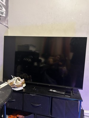 LED Flat Screen TV with Black Stand Modern Display Technology Sleek Black Design