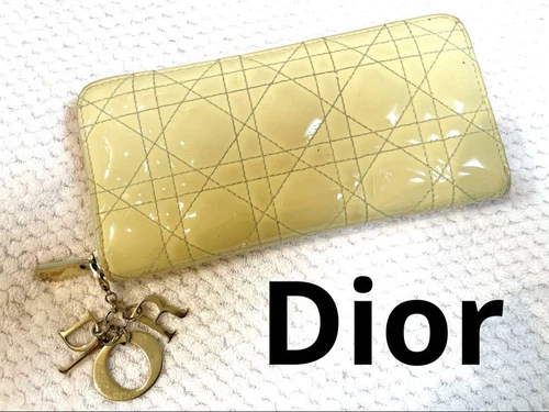Portefeuille long jaune Dior état d'usage authentique légère usure