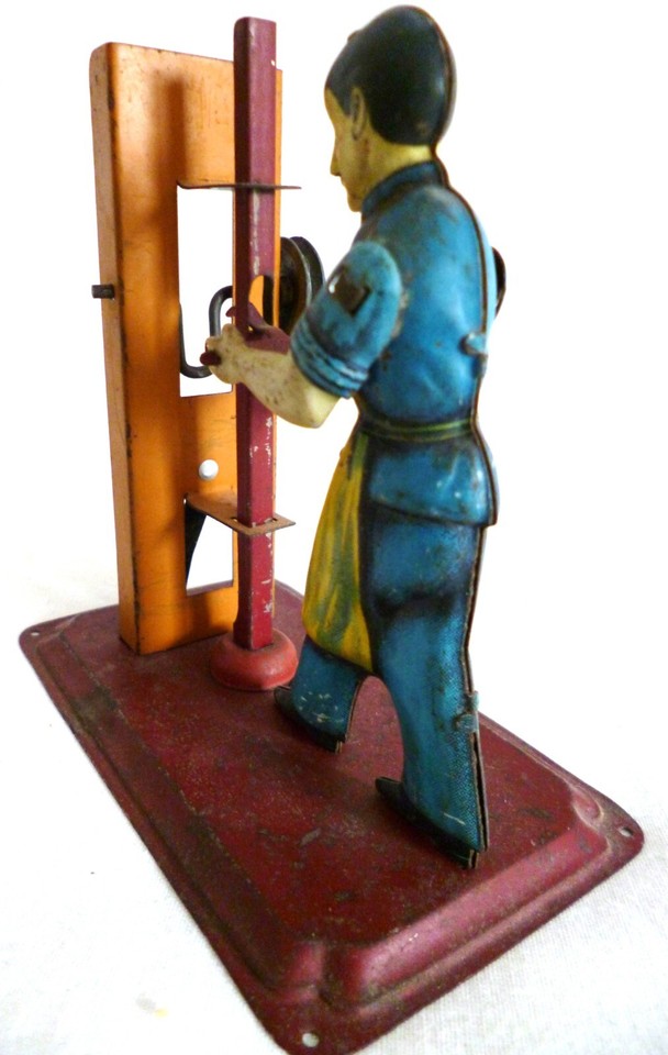 early 1920s man with a stamping press, a working model steam engine