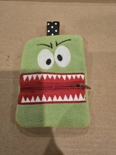 Green plush monster-themed pouch W/ zipper mouth & white jagged teeth