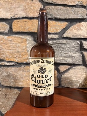 Vintage Whiskey Bottle In Orange Amber With Label