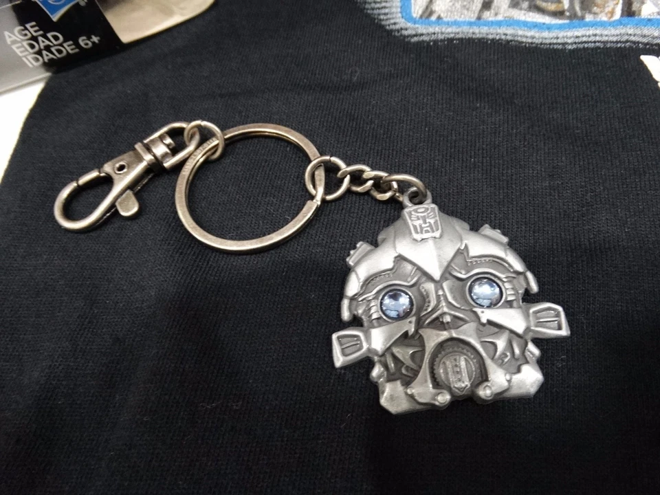 UNIVERSAL STUDIOS TRANSFORMERS SM T-SHIRT, AUTOBOT DRIFT TOY, KEYCHAIN, & LANYAR - Image 3 of 4