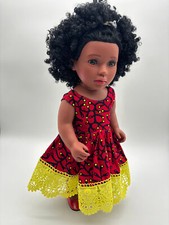 African doll in red authentic African fabrics dress with yellow ribbon