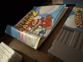 Carro Super Mario Bros 2 NES casi nuevo, caja sello ovalado caja Rev-A y manual (Dmg)