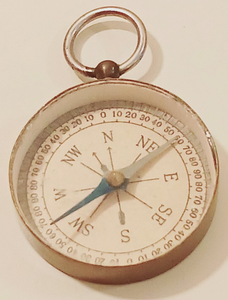 A solid brass pocket compass from WWII-era Japan with genuine maritime provenance — the kind of object that looks like it survived something.