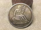 1 TROY OUNCE SILVER .999 STAMPED ON ONE SIDE W/ SEATED LADY LIBERTY ON OTHER