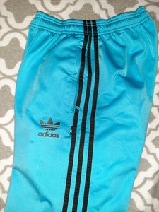 black adidas pants with blue stripes