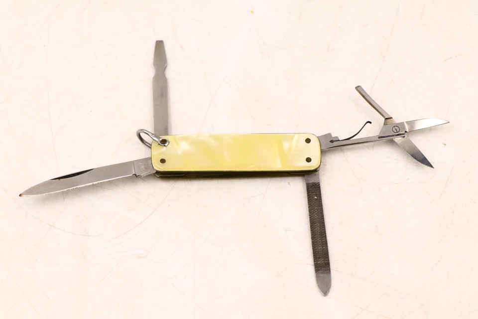 A mid-century Italian pearloid gentleman's knife-and-manicure multi-tool — the kind of dapper pocket accessory that no longer gets made.
