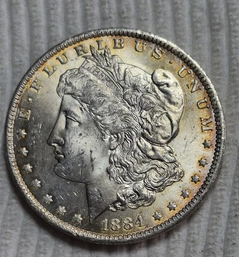 1884 O Morgan Silver Dollar. Estimated Uncirculated 64. Obv Edge Toned. A0831.