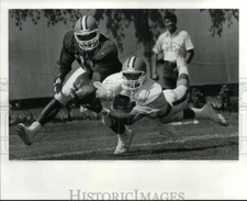 1987 Press Photo Webster Slaughter catching against Frank Minifield - cvb35248