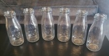 6 Embossed "Dairy" Milk Bottles 6 " tall