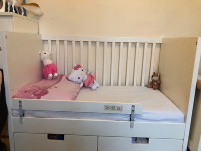 white cot with storage