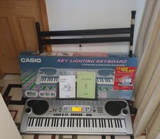 Casio LK-73 Key Lighting Keyboard, stand, instructions, songbook  AC Adapter