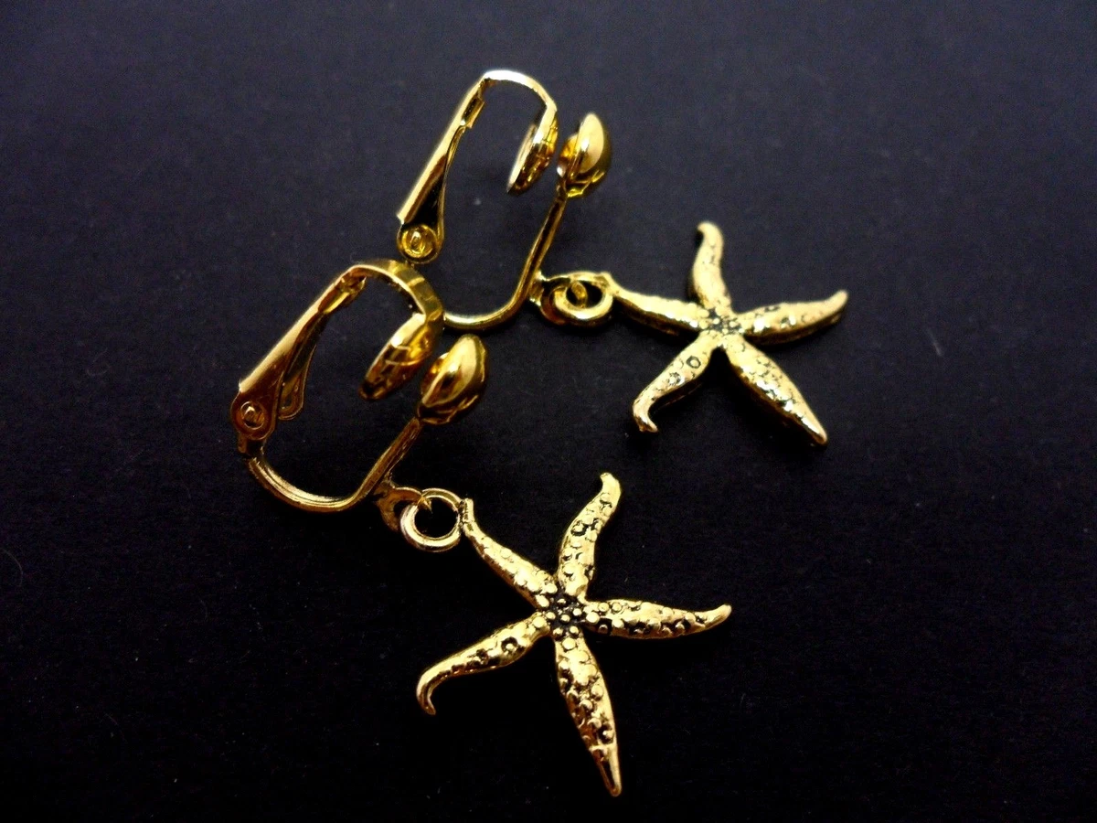 A PAIR OF CUTE LITTLE GOLD COLOUR DANGLY STARFISH CLIP ON EARRINGS