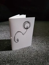 small handmade sketchbook with hand-drawn cover, 24 pages, 3" x 4.5"