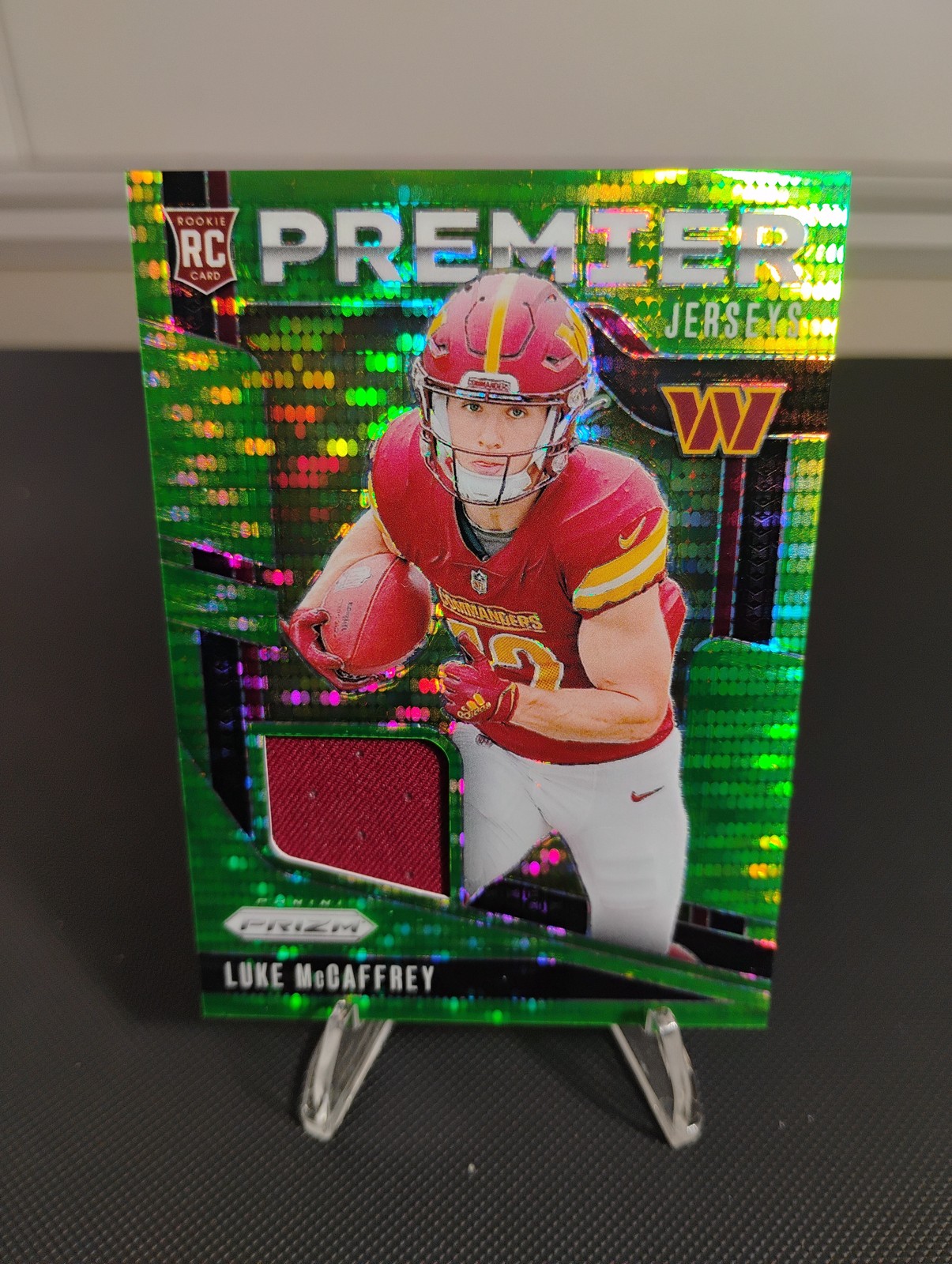 2024 Panini Prizm #PJ-LMY Luke McCaffrey Premier Jerseys Neon Green Pulsar