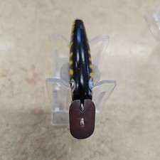 Vintage wooden fishing lure with metal fins