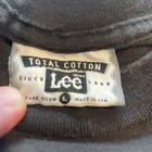 White VTG 90s LEE tag with black text: total cotton, since 1889, care over L, made in USA.