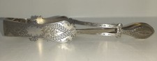 Silver plated sugar tongs with cross over action.