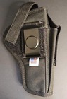 Black nylon, USA made, ambidextrous holster with silver belt clip and magazine holder, visible stitching and white tag.