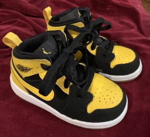 black and yellow infant jordans