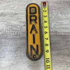 Vintage DRAIN Metal Sign Vertical Embossed Orange oval 10" x 3"