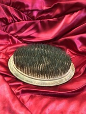 vintage round metal flower frog with numerous upright pins.