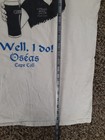 White vintage cotton T-shirt with black Guinness logo, “Well, I Do!” text, and “Osheas Cape Cod” printed below.