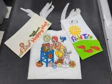 Vintage McDonalds Collection. 6 Baby Bibs, 1 Vinyl Bag And 1 Paper Hat