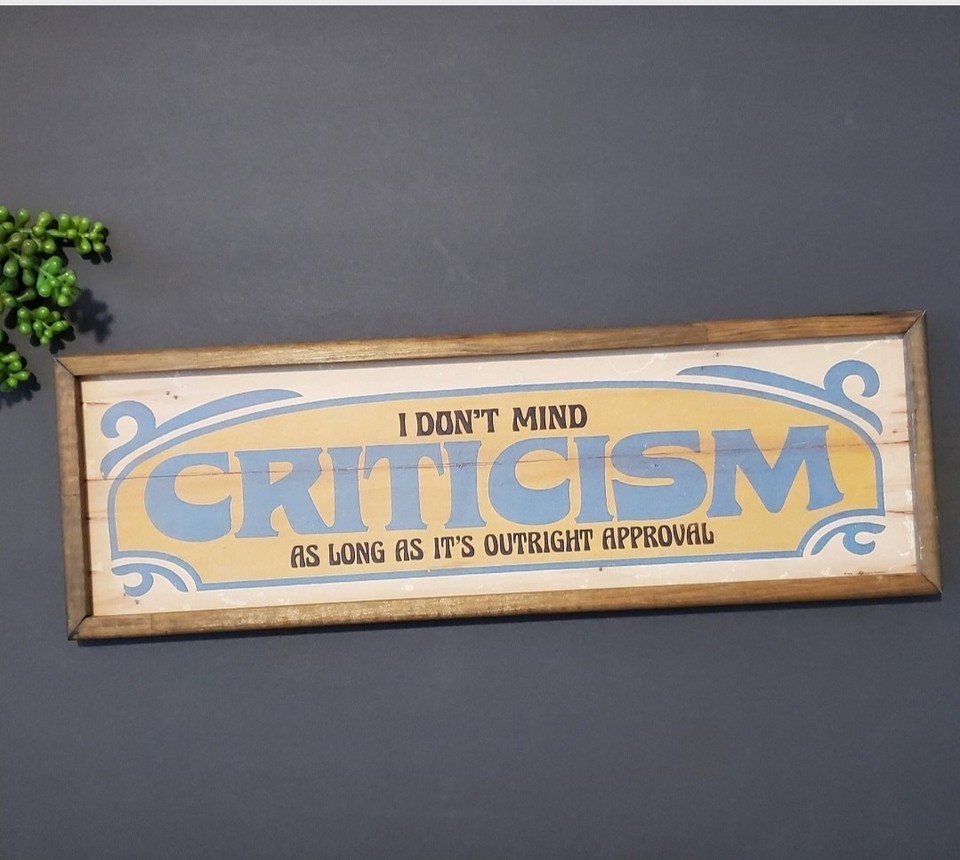 A legit 1970s Douglas A. Murphy 'Criticism' novelty sign — these were the snarky office humor of their era and are now genuinely collectible conversation pieces.