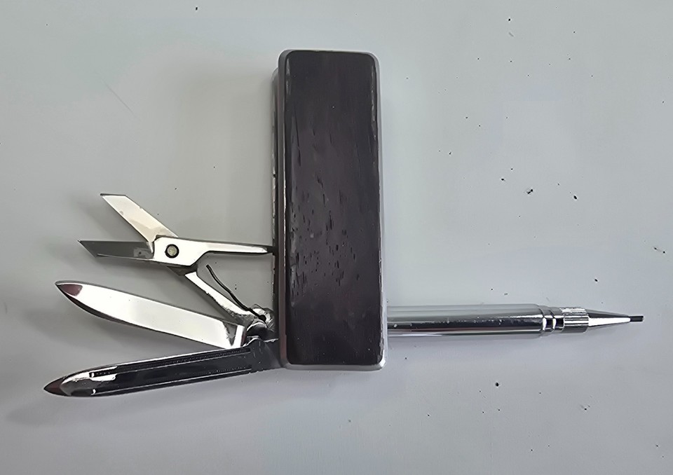 A wood-handled gentleman's multi-tool with pen, scissors, and file — the kind of refined pocket kit a dandy from another era would never leave home without.