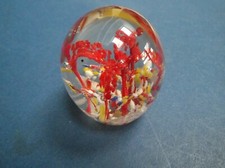 small Glass Paperwieght red crown like design blue red yellow white background 