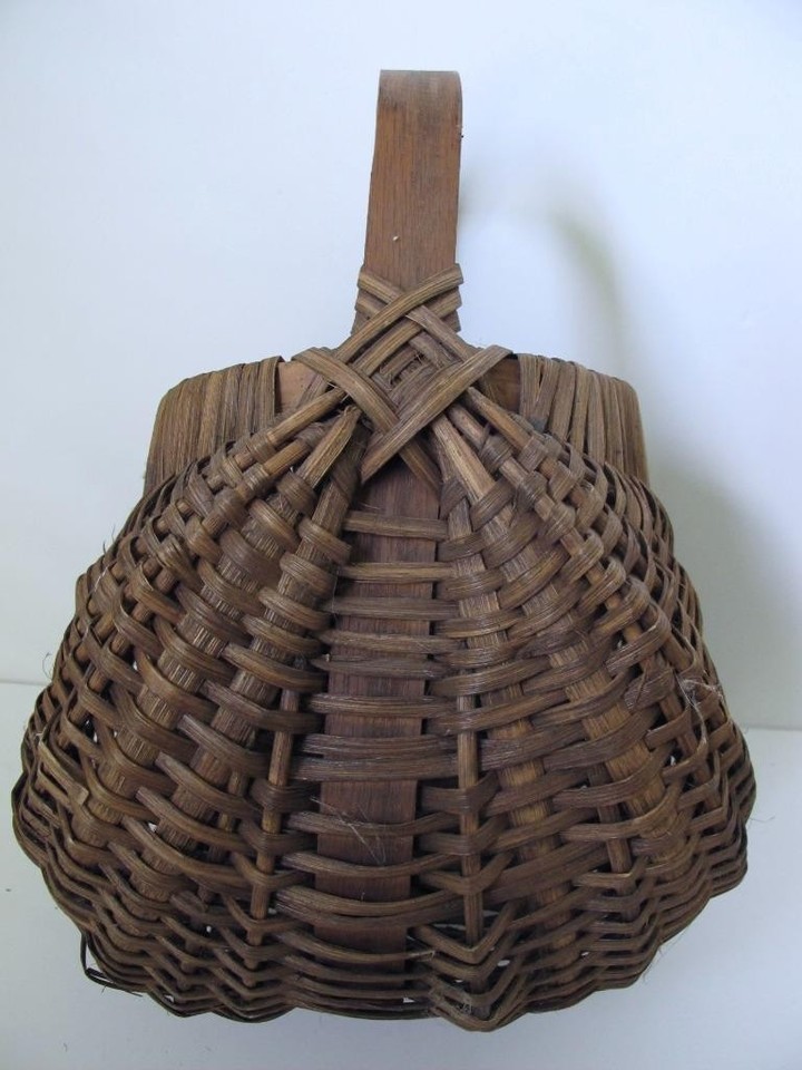 This vintage hand-woven buttocks egg gathering basket is a unique
