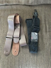 TWO NEW GUITAR STRAPS, ONE BROWN LEATHER, ONE BLACK PATTERNED NYLON, NOS