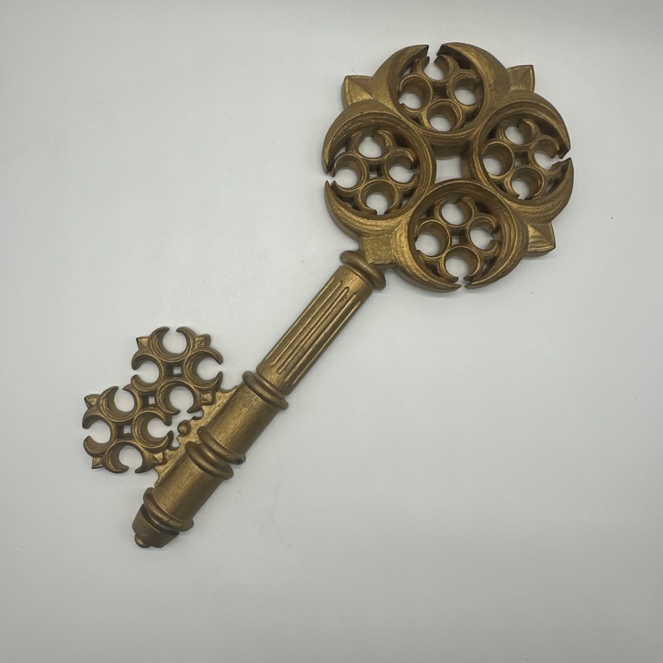 An 18" gold-tone key motif wall sculpture from the 1960s — the kind of quirky MCM statement piece interior designers hunt for.
