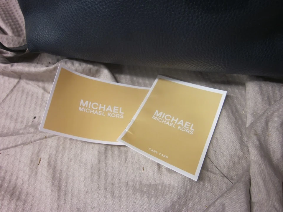 Mochila Michael Kors Rhea delgada de cuero granulado azul borde dorado precio de venta sugerido por el fabricante 378 USD - COMO NUEVA Foto 2 de 4