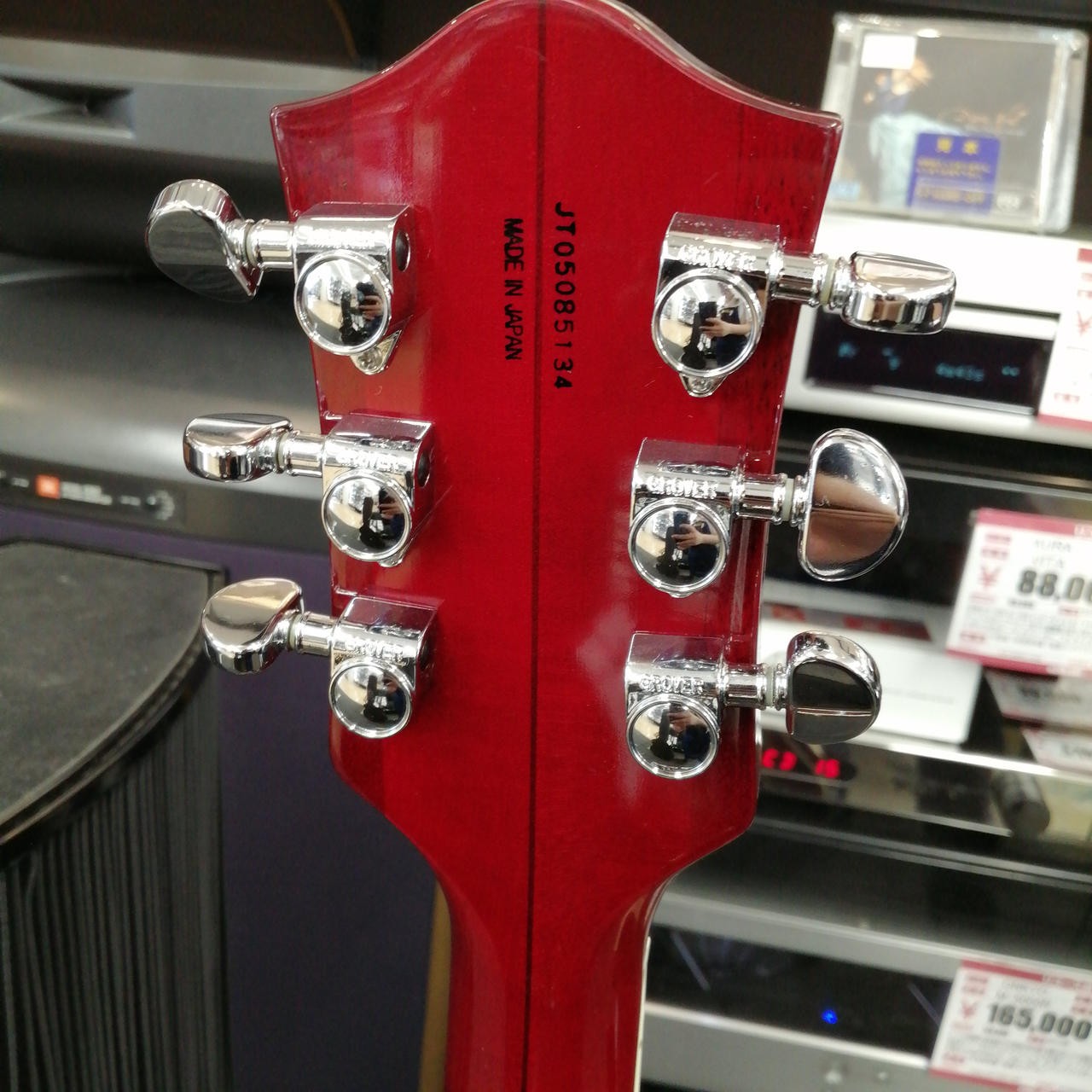 Red GRETSCH G6119 full-body acoustic guitar with silver hardware and engraved specifications on the back.