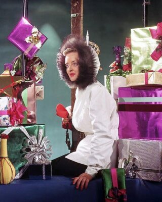 Bette Davis surrounded by Christmas Presents 24x36 inch Poster