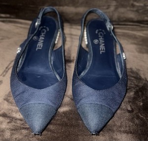 Chanel denim slingback flats with faux pearl accents in dark navy blue. 