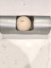 1940'S SPALDING/CANADA OLYMPIC SLEEVE WITH TWO GOLF BALLS ONE WITH ORIGINAL SEAL