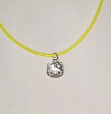 Hello Kitty Small Silver Tone Pendant on 18+ Inch Yellow Cord Necklace 
