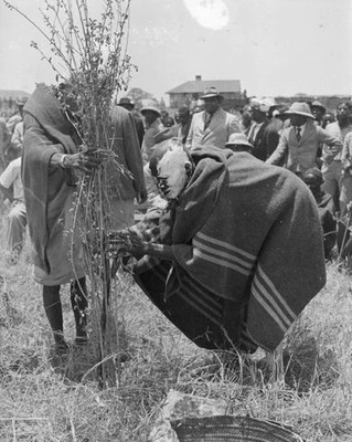 Mwaura a witch doctor places Thenge Stone carefully into support m- Old Photo