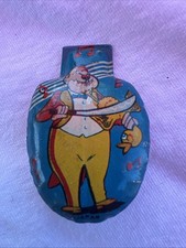 vintage tin lithographed clicker toy, from the 1950s, depicting a clown