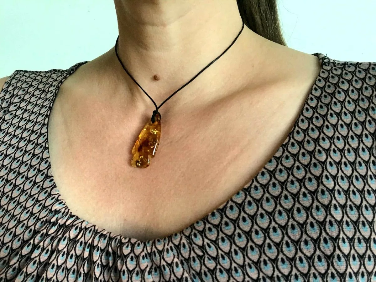 Carved store amber pendant