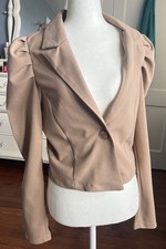 cropped blazer featuring puff shoulders and a single-button closure