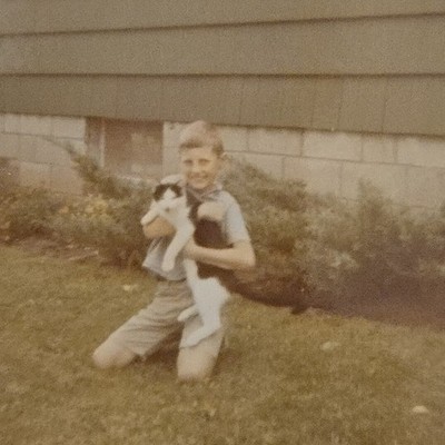 Vintage Color Photo Snapshot of Boy Smiling While Holding Black and White Cat