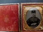 Tintype of woman in leather embossed daguerreotype case, lyre hinge