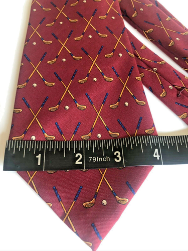 Red silk tie with small white polo player silhouettes and gold clubs, measuring 56 inches long.