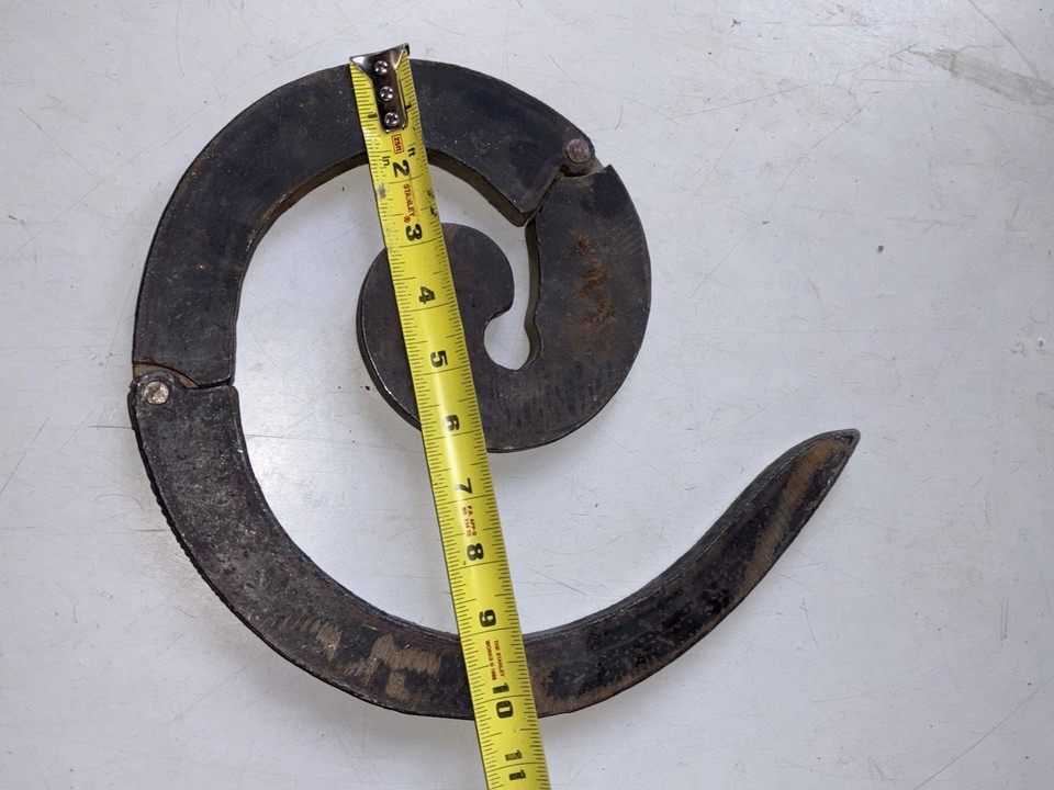A blacksmith's scroll bending tool is visually dramatic — heavy, curved, purposeful — the kind of thing that looks like it belongs in a fantasy forge and makes an incredible desk or shelf piece.