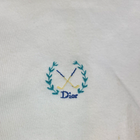 White VTG Christian Dior men’s V-neck sweater with blue monogram and gold-white cross golf logo on chest.